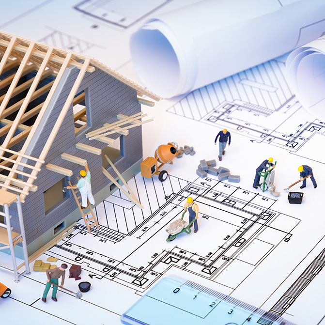 house under construction on blueprints - building project